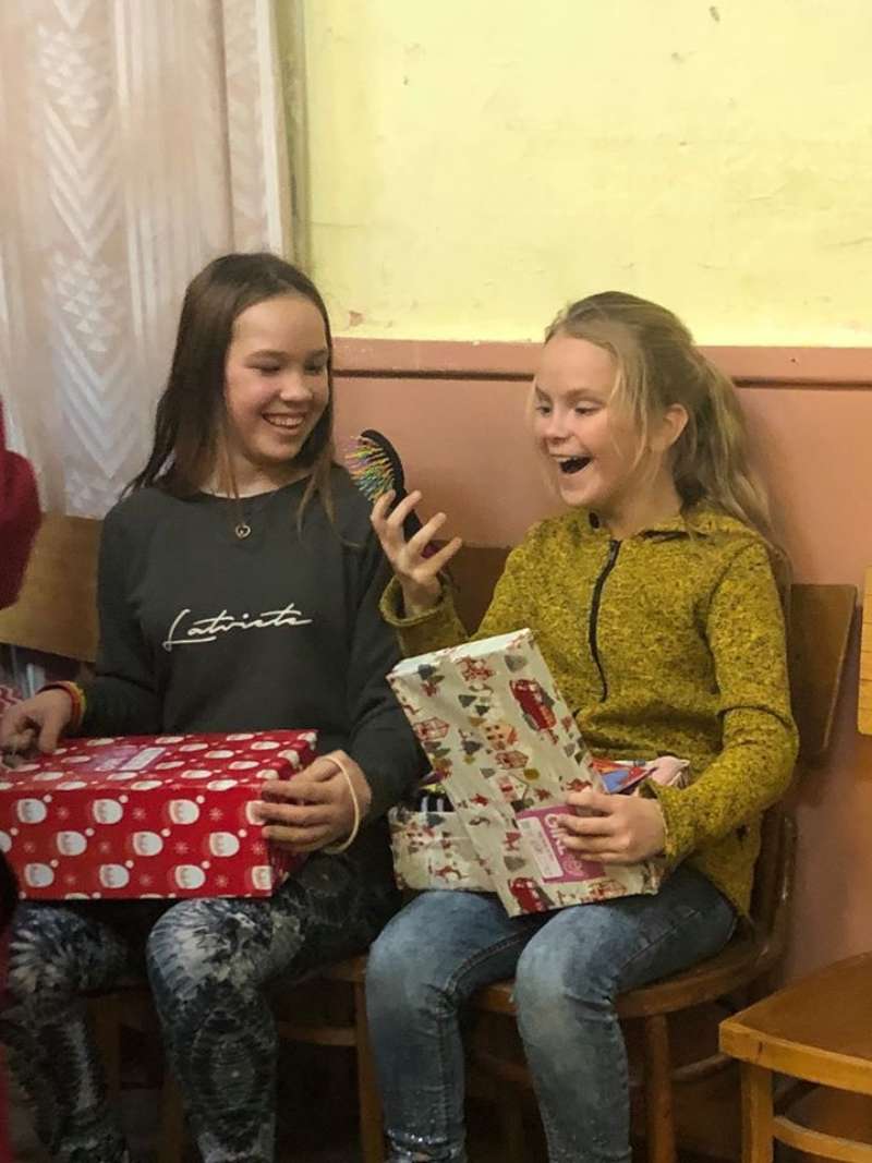 Girls receiving gifts latvia dec19
