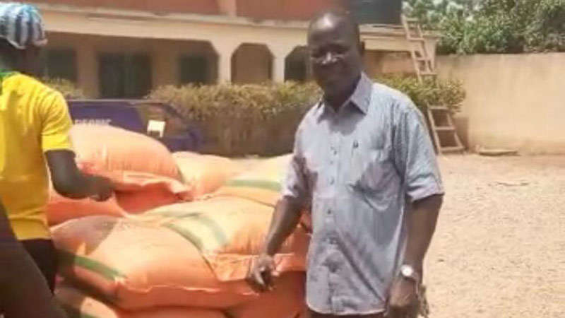 Etienne with bags of corn cropped