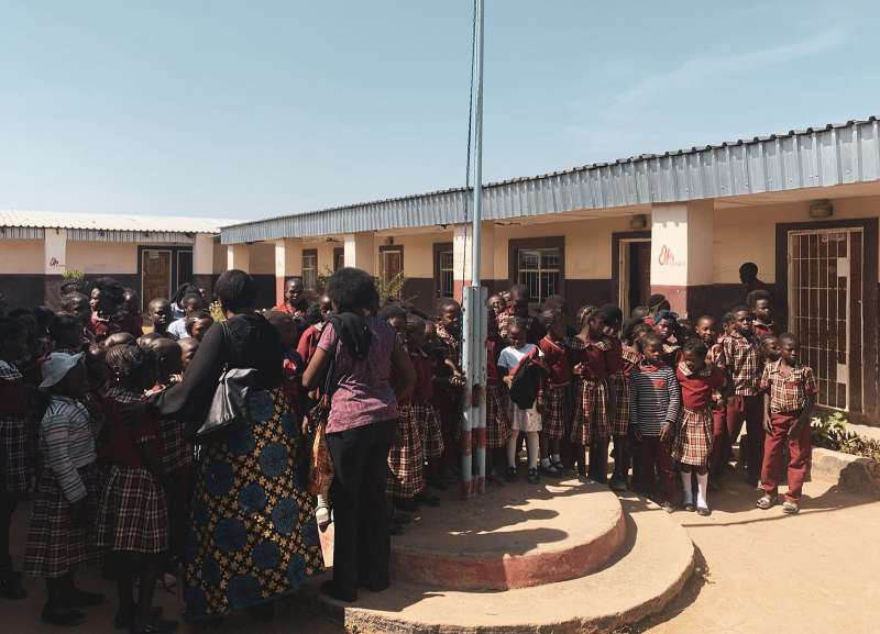 Crowd of kids in school courtyard Zambia