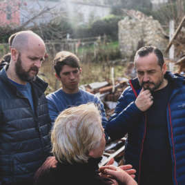 Neil, Anatol and Akil talking to lady affected by the earthquake