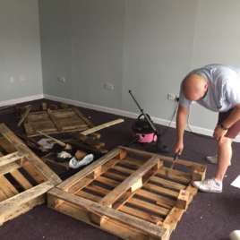 Neil hammering a wooden pallet (Living Room, Richhill)